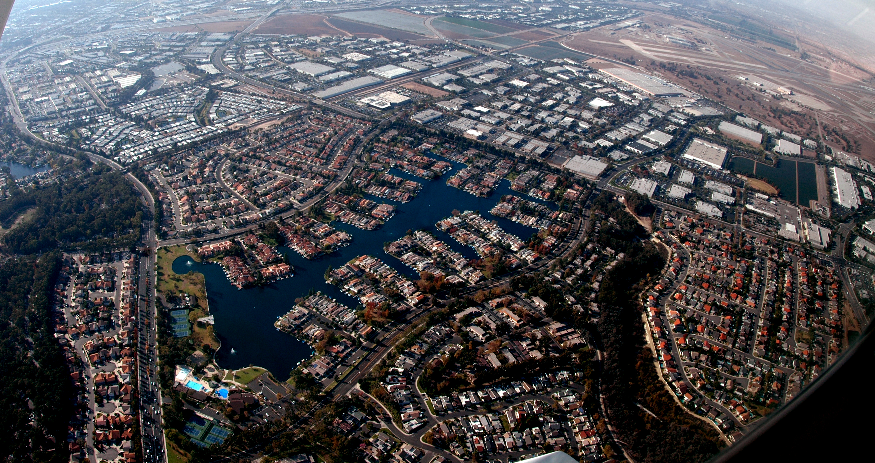 Aerial view of Lake Forest, California showing residential neighborhoods, lakes, and nearby commercial areas