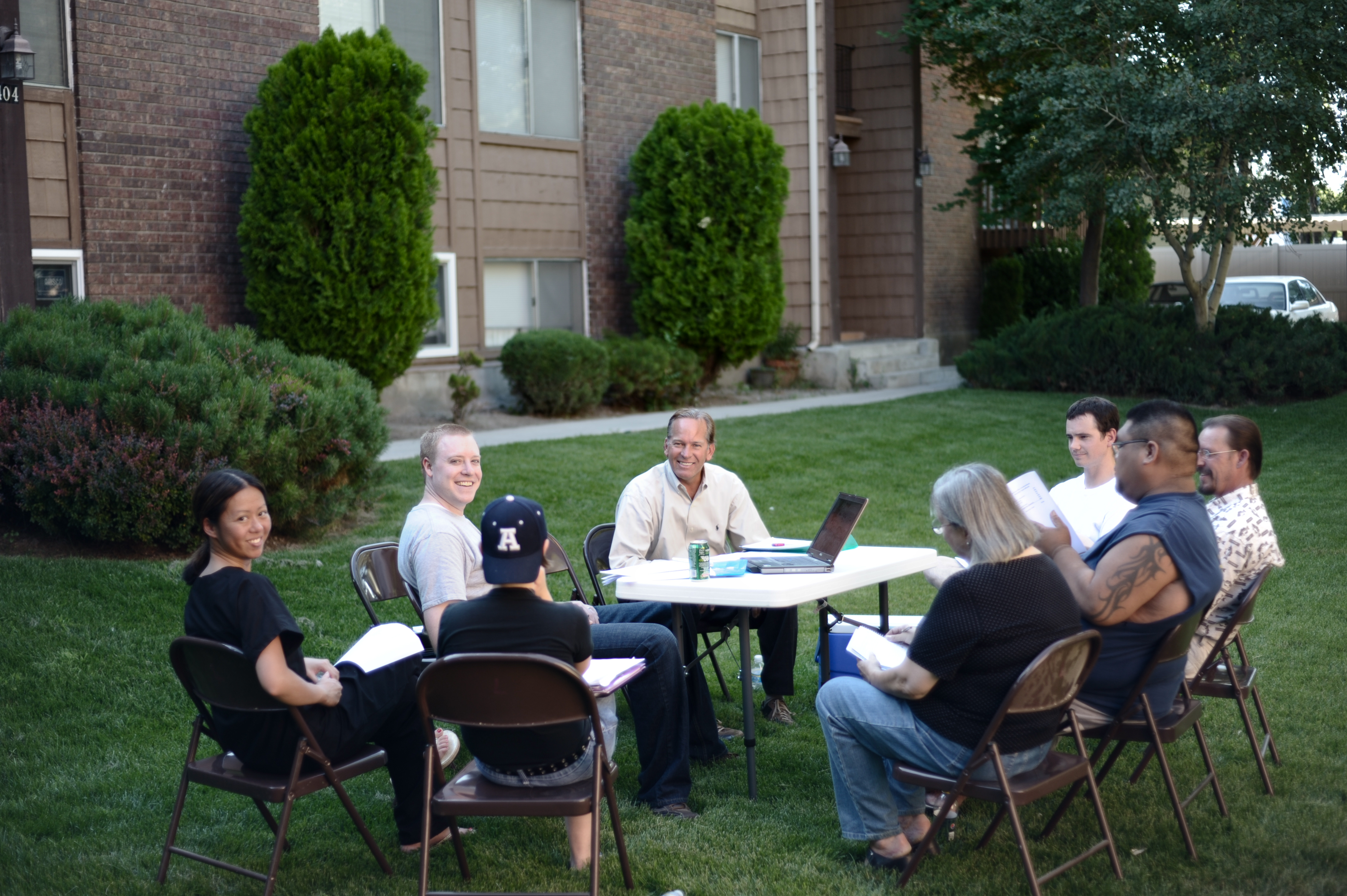 Homeowners association board members reviewing papers during an outdoor meeting
